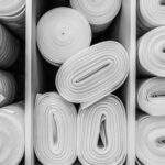 Industrial white foam rolls or thermal insulation materials in a hardware store. Laminate and parquet flooring in rolls close-up. Corrosion-resistant, environmentally friendly and safe material.